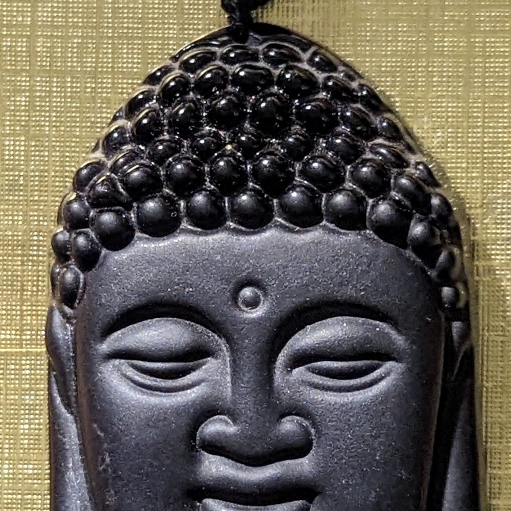 Black lightweight.    On a beaded necklace that is